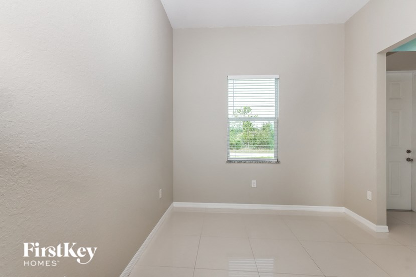 an empty room with a window and a door