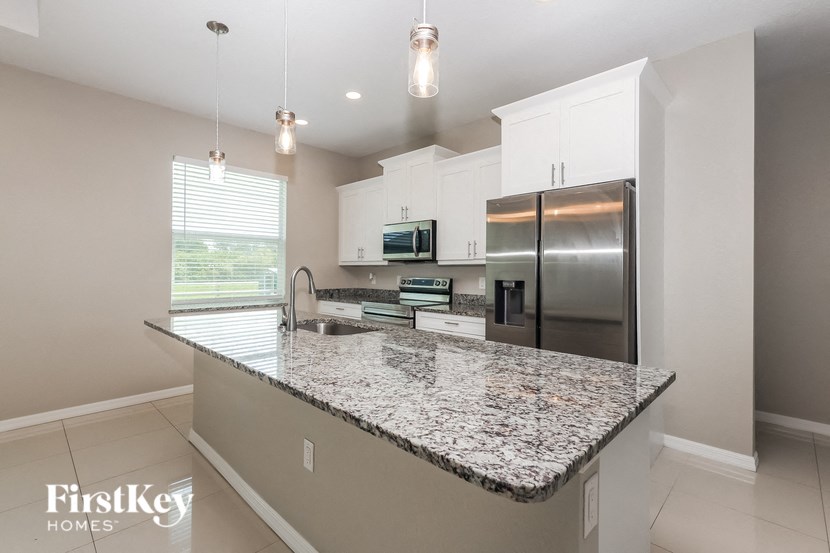 a modern kitchen with granite counter tops and stainless steel appliances