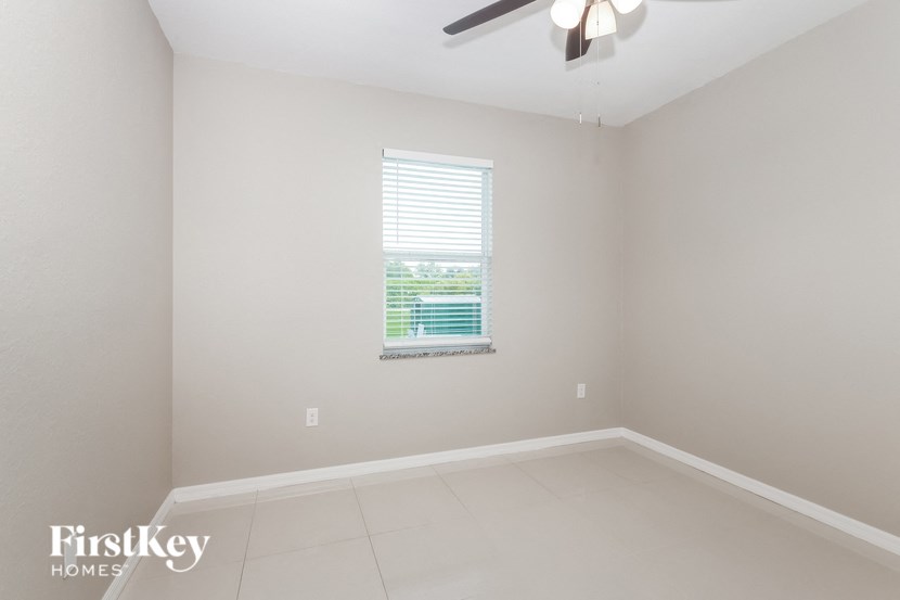 a empty room with a window and a ceiling fan