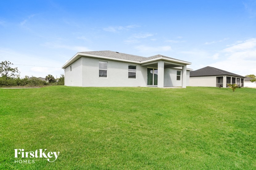 a white house with a lawn in front of it