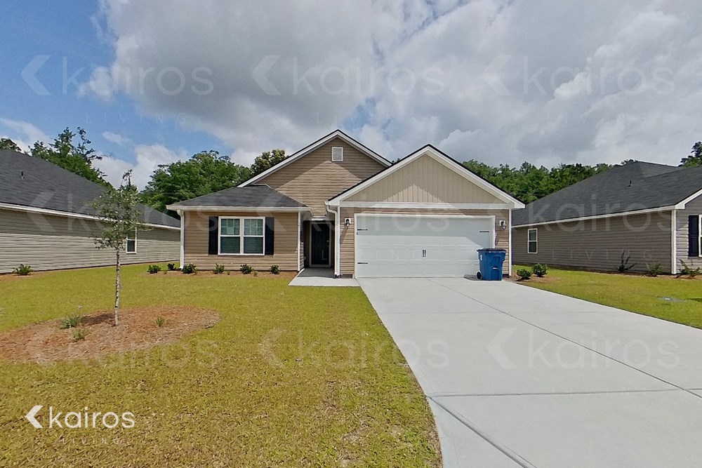 a home with a white garage door and a driveway