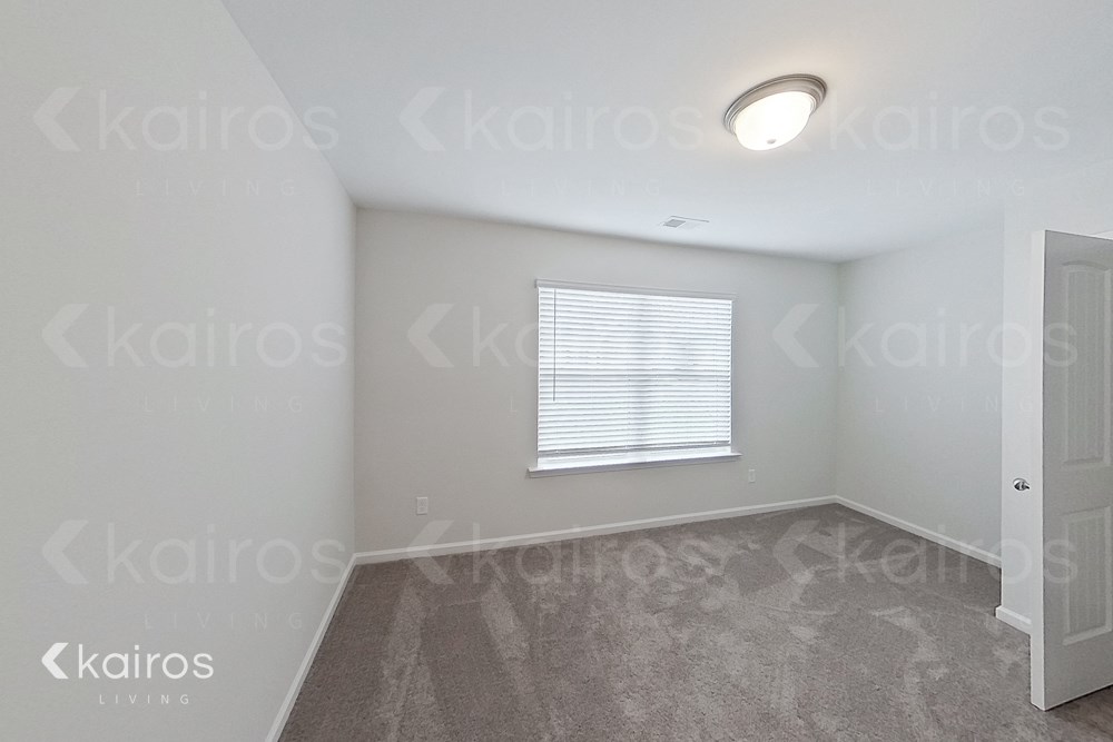 an empty room with a window and a door