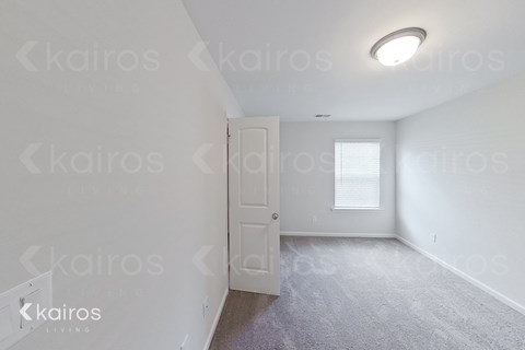 a bedroom with white walls and a white door