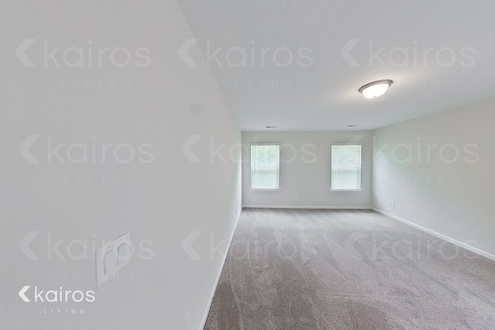 an empty living room with white walls and a white carpet