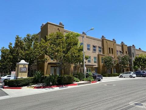 A street view of a building with a sign that says "Sunrise".