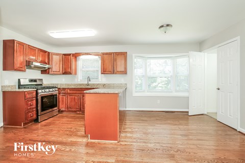 a kitchen with wooden cabinets and a stove and a sink