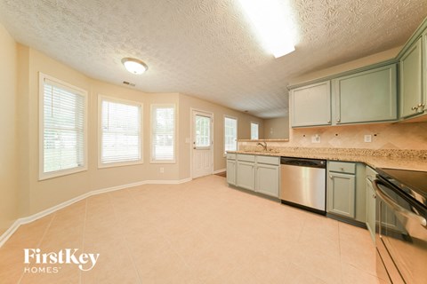 a kitchen with a sink and a dishwasher and a counter top