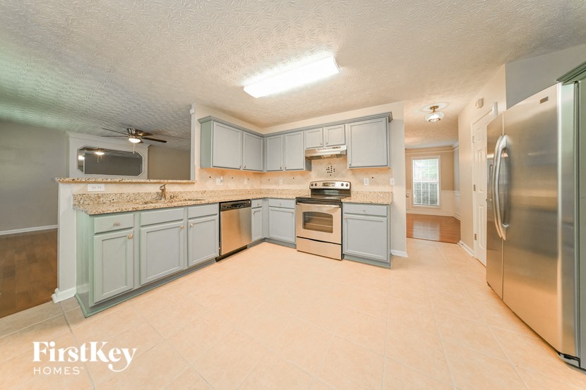 a kitchen with stainless steel appliances and blue cabinets