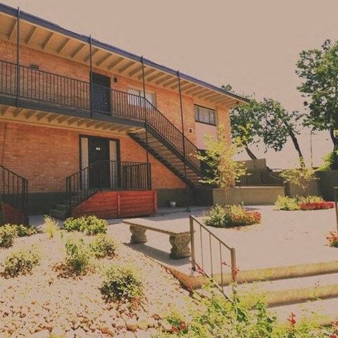 a building with stairs and a courtyard in front of it