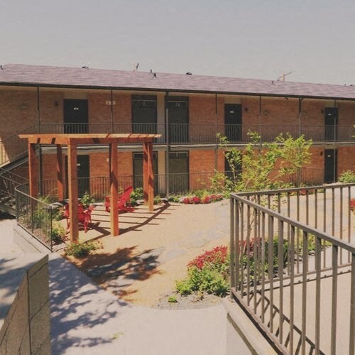 a courtyard in front of a brick building