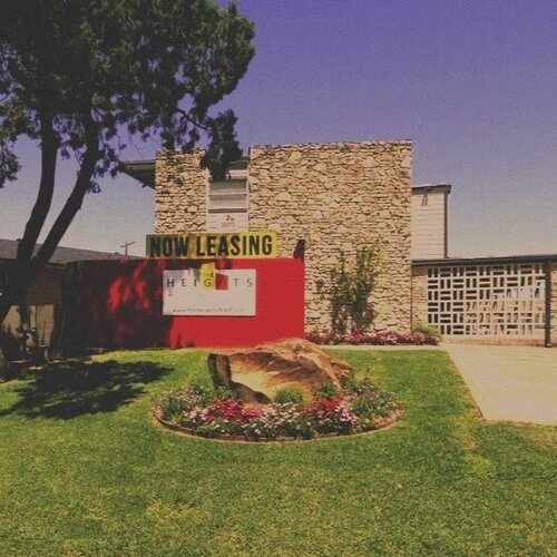 a now leasing sign in front of a building