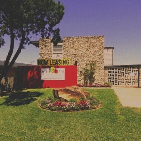 a now leasing sign in front of a building