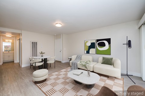 A living room with a white couch and a coffee table.