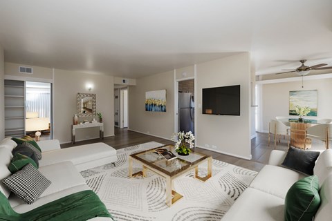 A living room with a white couch and a coffee table.