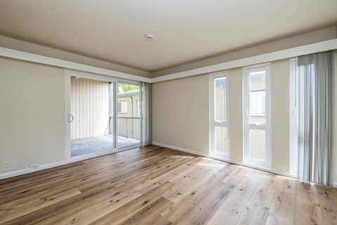 A room with wooden floors and white walls.