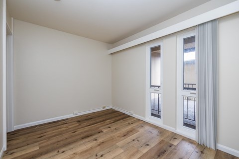 A room with wooden floors and white walls.