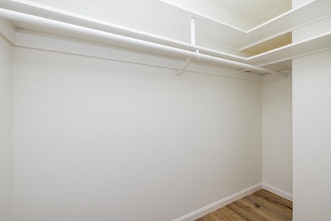 A white room with a wooden floor and white walls.