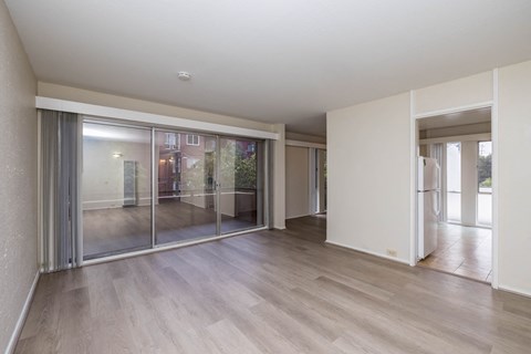 a living room with sliding glass doors and a hard wood floor