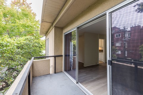 a balcony with a sliding glass door and a patio