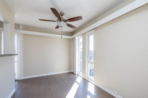 A room with a ceiling fan and a marble countertop.