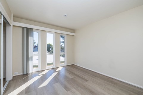 A room with a wooden floor and white walls.