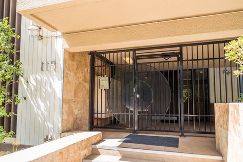 A building entrance with a gate and a round glass door.