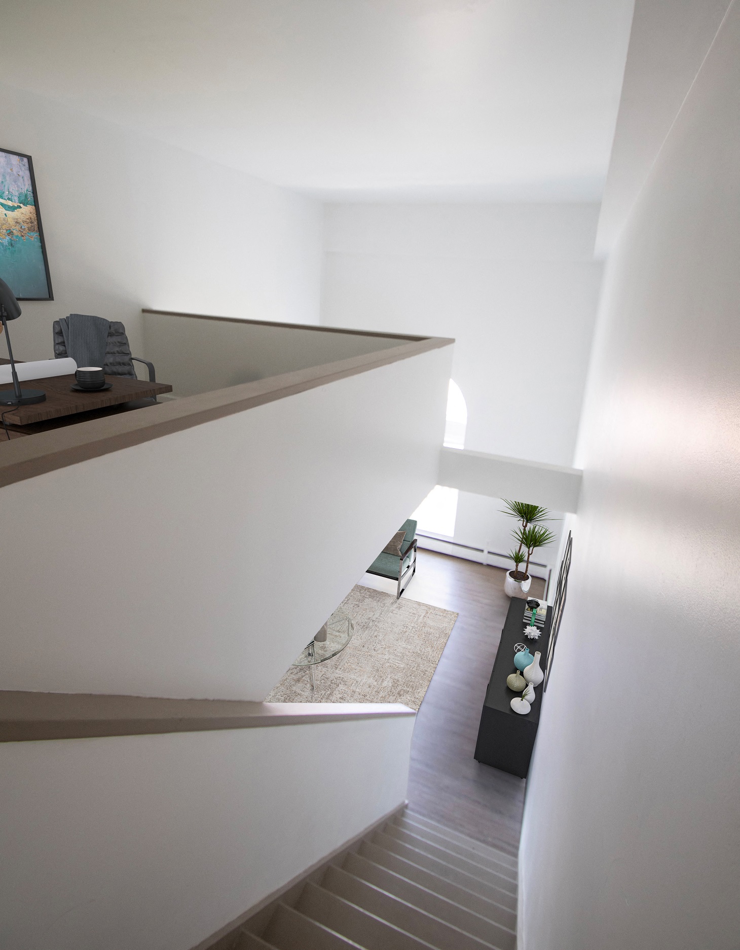 a view down the stairs of a living room with a potted plant