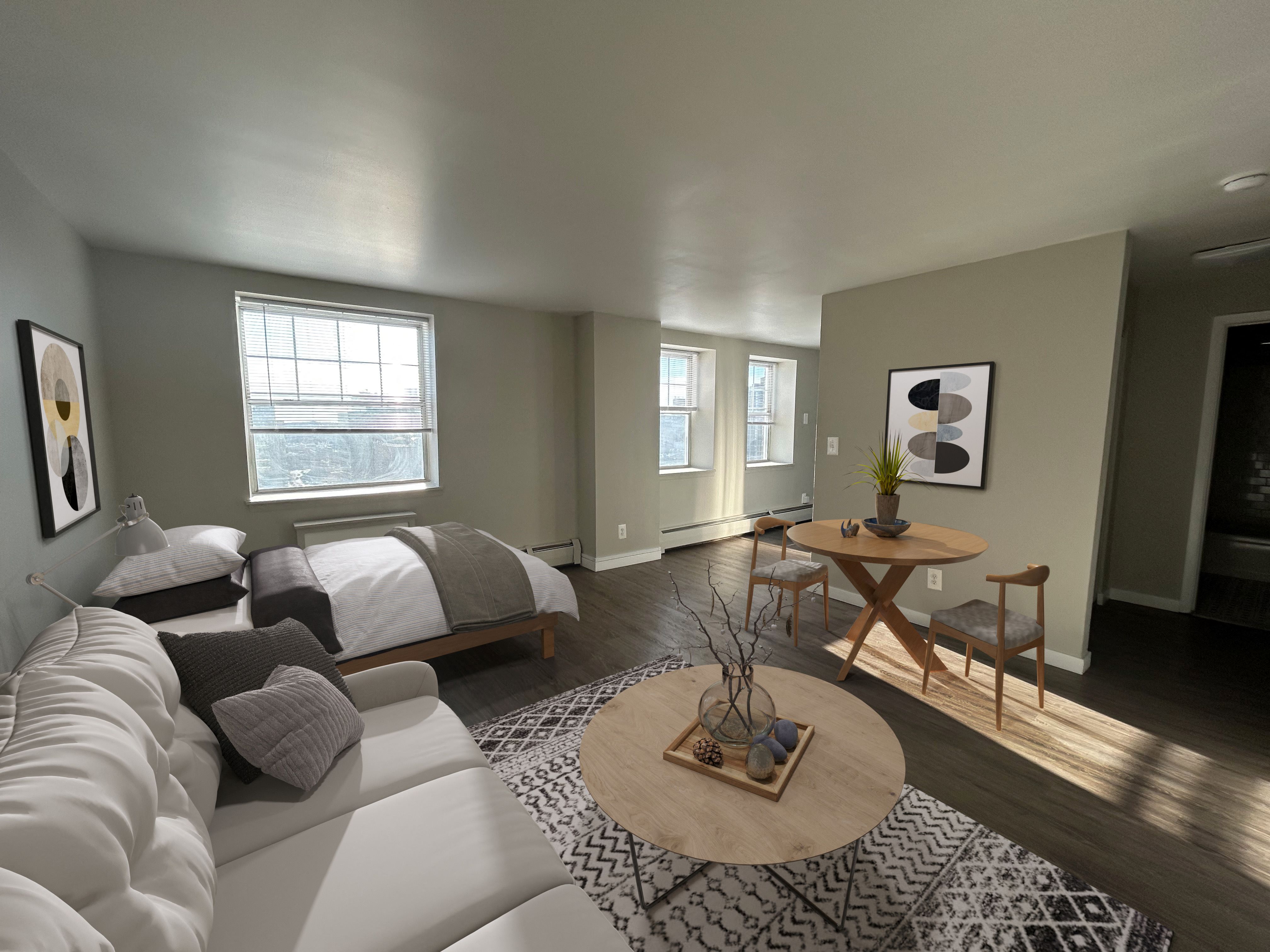 A living room with a white couch and a wooden coffee table.