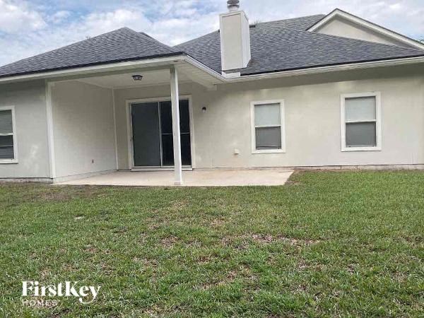 a white house with a yard in front of it