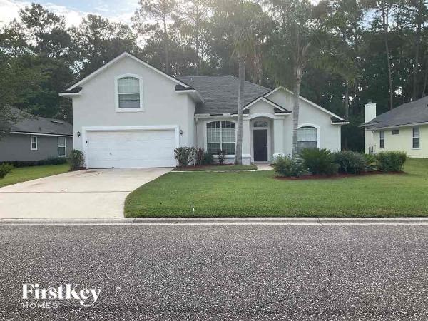 a white house with a driveway and a garage door