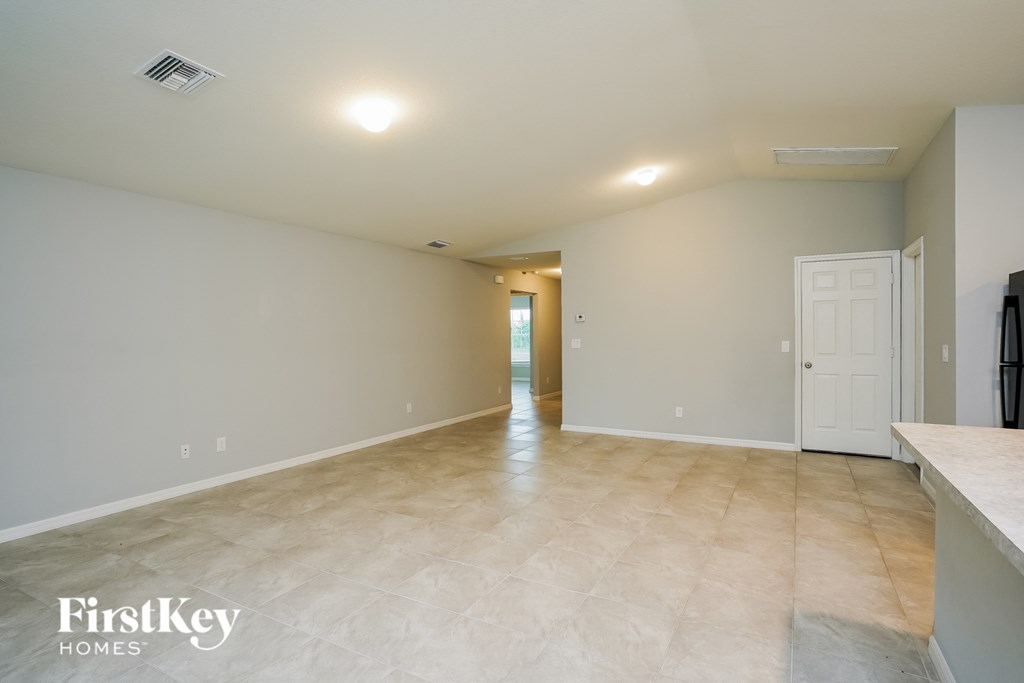 the spacious living room and kitchen are open to the dining room
