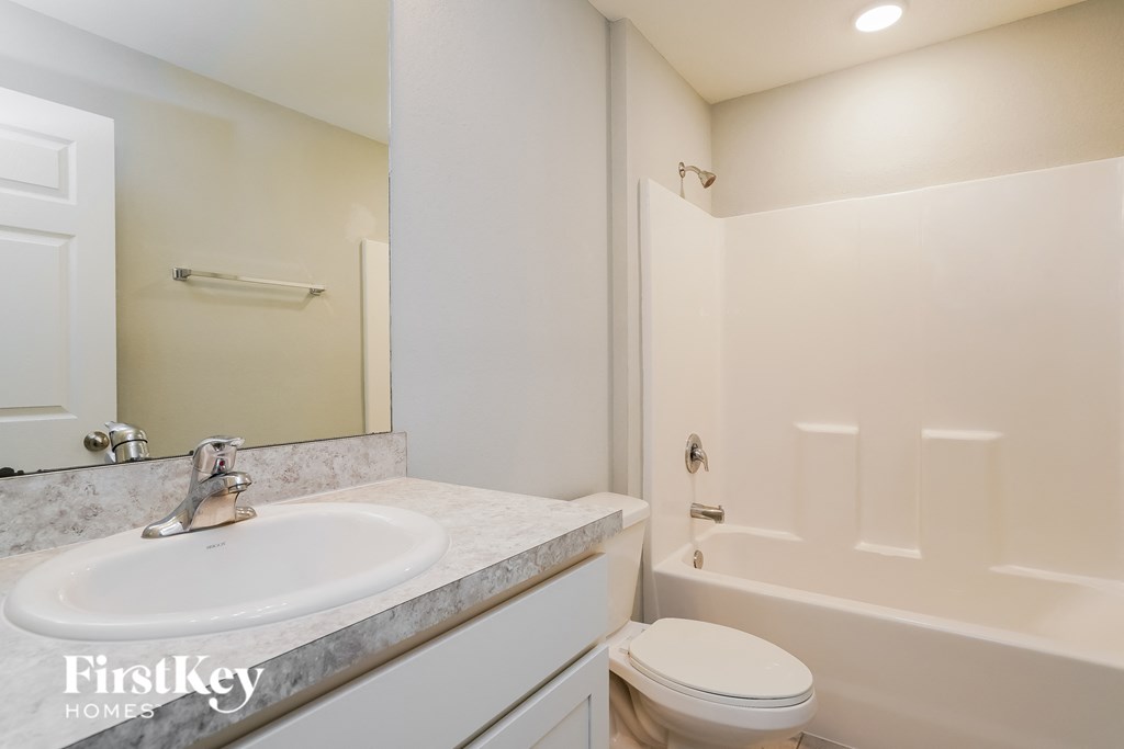 a bathroom with a sink and a toilet and a shower