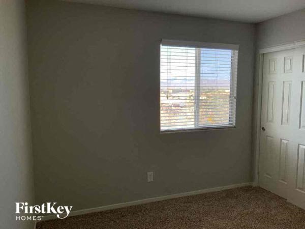 an empty room with a window and a door