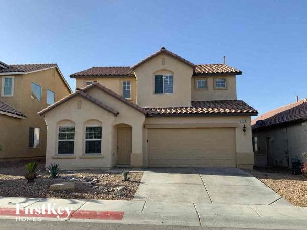 a beige house with a garage and a driveway