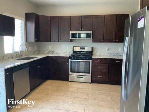 a kitchen with a stove and a refrigerator