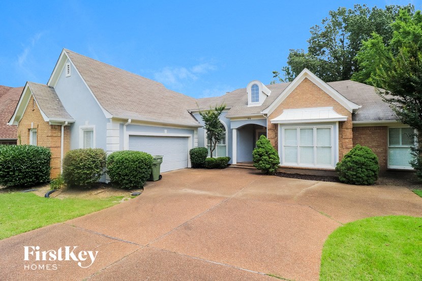 a white house with a driveway and a white garage door