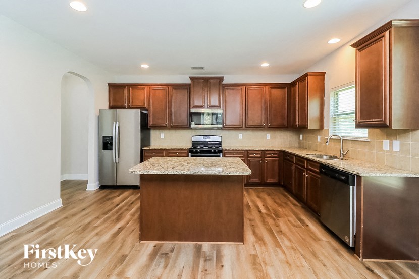a kitchen with wooden cabinets and stainless steel appliances