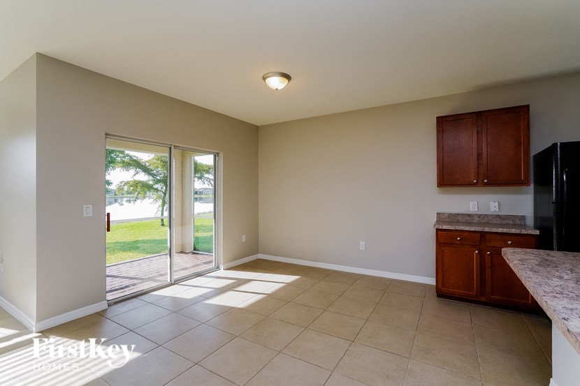 a kitchen with a sliding glass door leading to a patio