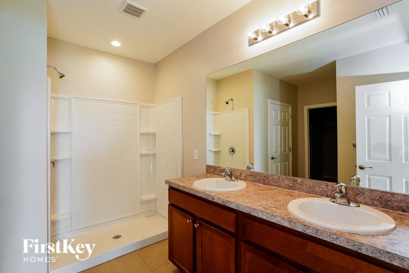 a bathroom with two sinks and a large mirror