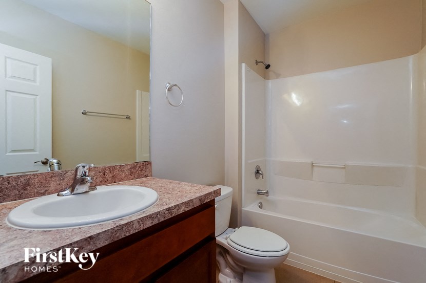 a bathroom with a sink toilet and a shower