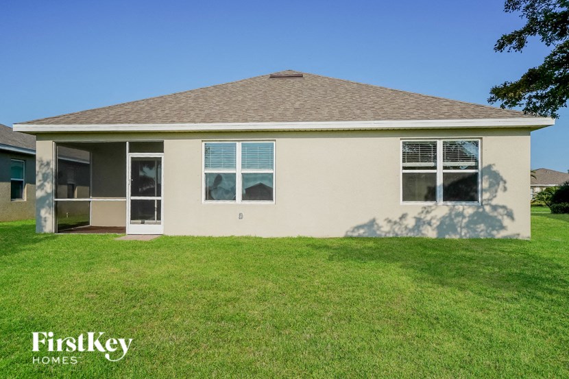 a cream colored house with a grassy yard