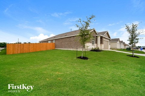 a home with a yard and a wooden fence