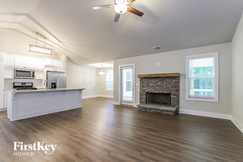 A spacious living room with a fireplace and a television.