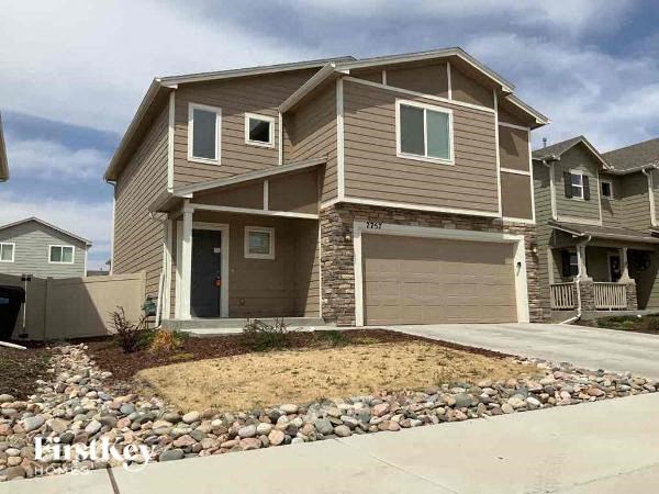 a house with a driveway and a yard with rocks