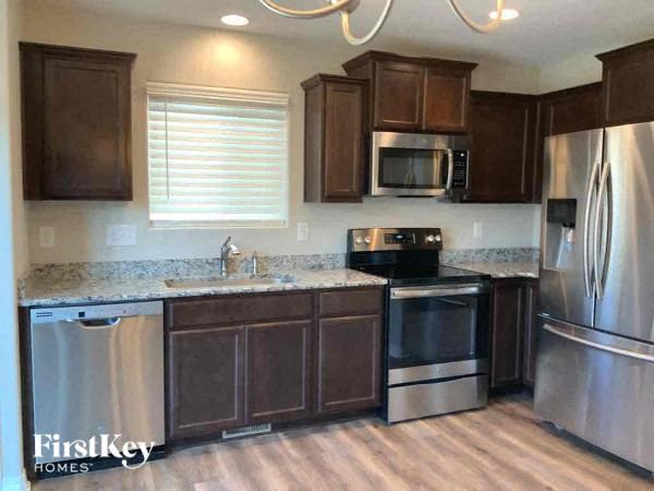 a kitchen with stainless steel appliances and wooden cabinets