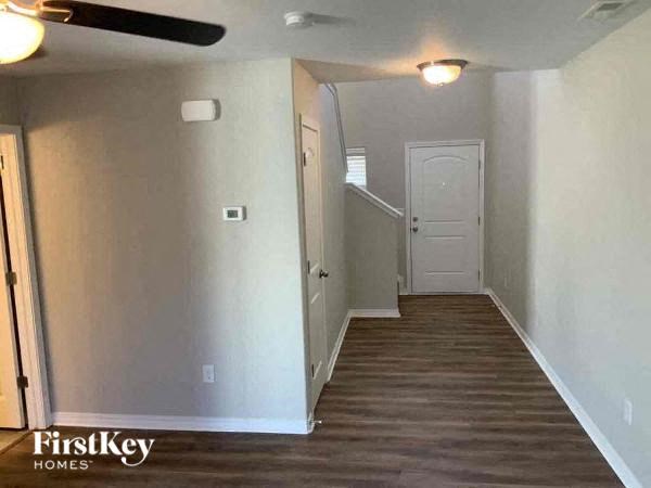 a hallway with white walls and a white door