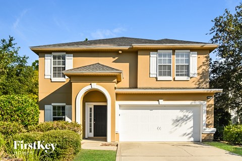 a yellow house with a white garage door