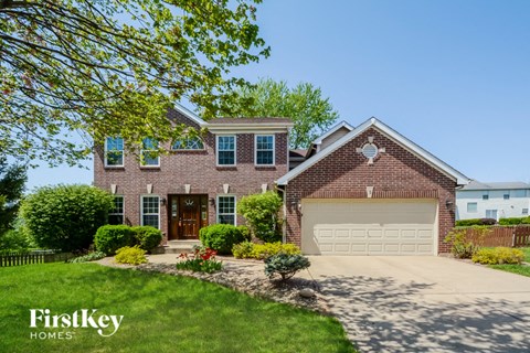 a large brick house with a white garage door
