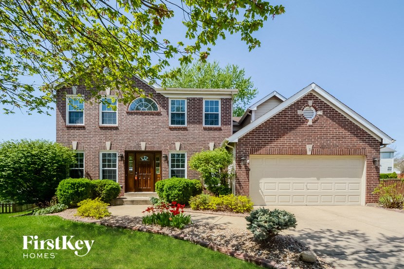 a large brick house with a white garage door