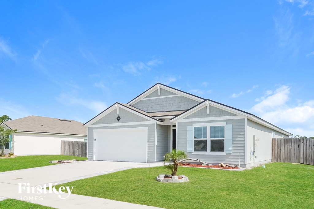 a blue house with a lawn in front of it